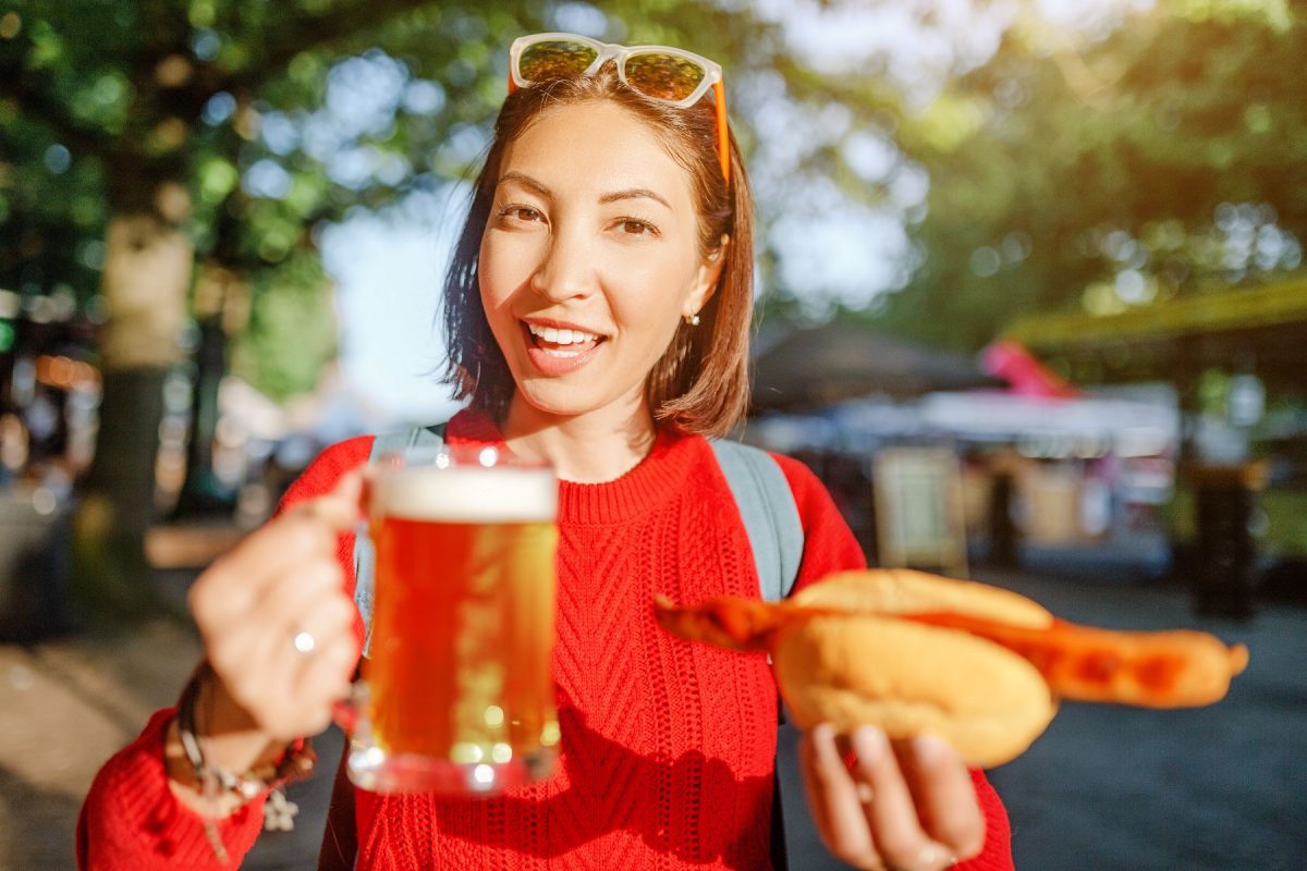 women with beer and sausage at festival